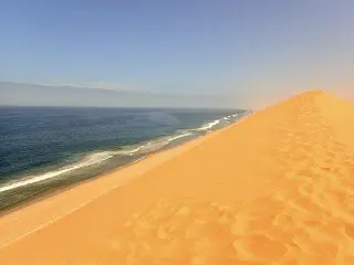 Sand Dunes Rise Up From The Beach Walvis Bay Namibia