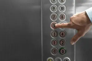 Forefinger Pressing The Fifth Floor Button In The Elevator