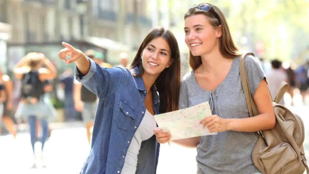 15 Easy Ways To Save Money While Traveling 17 Local Girl Helping Tourist