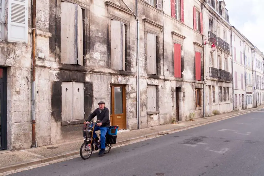 Exploring The Treasures Of France’s Dordogne Region: A Journey Through History, Culture, And Natural Beauty &Raquo; Man Riding Bike In Brantome Brantome France Copyright 2019 Ralph Velasco 1024X683 1
