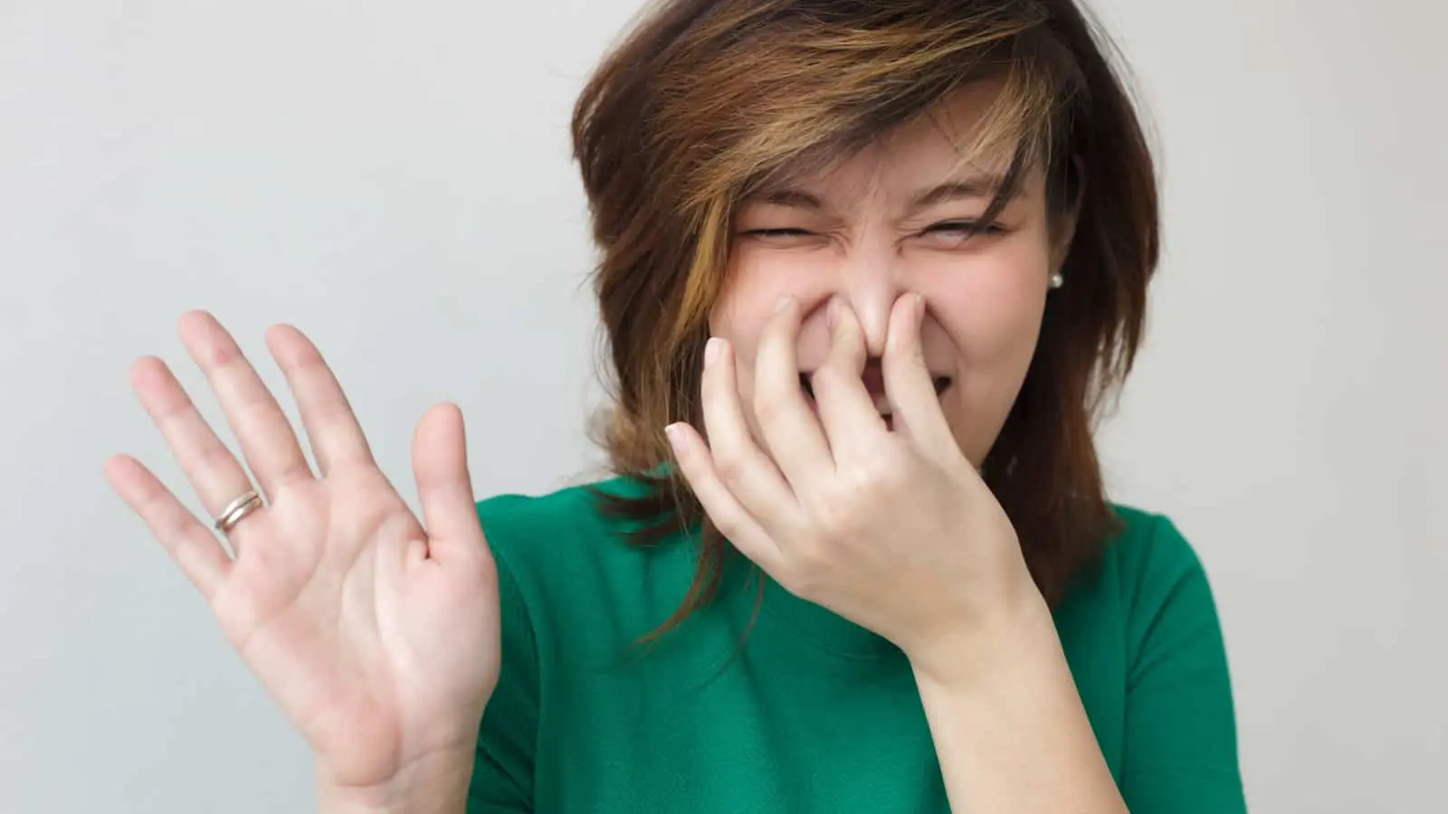 Woman Plugging Nose Stink 