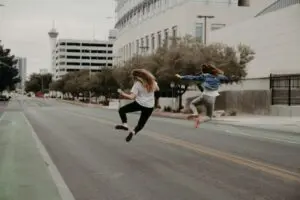 Two Girls Leaping Full Of Joy And Contentment