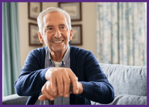 Understanding Multiple Sclerosis &Raquo; Photo Of A Smiling Senior Man Sitting On A Sofa With His Hands Resting On His Cane Canva Border Added 1 300X215 1