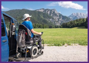 Traveling With A Disability Or Chronic Illness &Raquo; Photo Of A Young Man In An Electric Wheelchair Using A Lift To Get Out Of A Van While Parked In Front Of A Scenic Vista Of Mountains Canva Border Added 1 300X215 1
