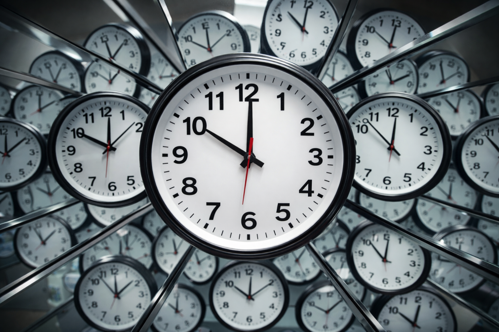 A Clock With A Lot Of Other Clocks In What Looks Like A House Of Mirrors.