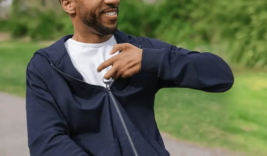 Man In Wheelchair Zipping Sweatshirt