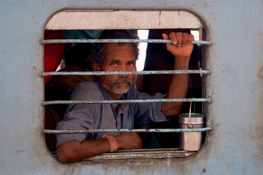 Man On Train With Food Tin At Delhi Train Station In India By Ralph Velasco