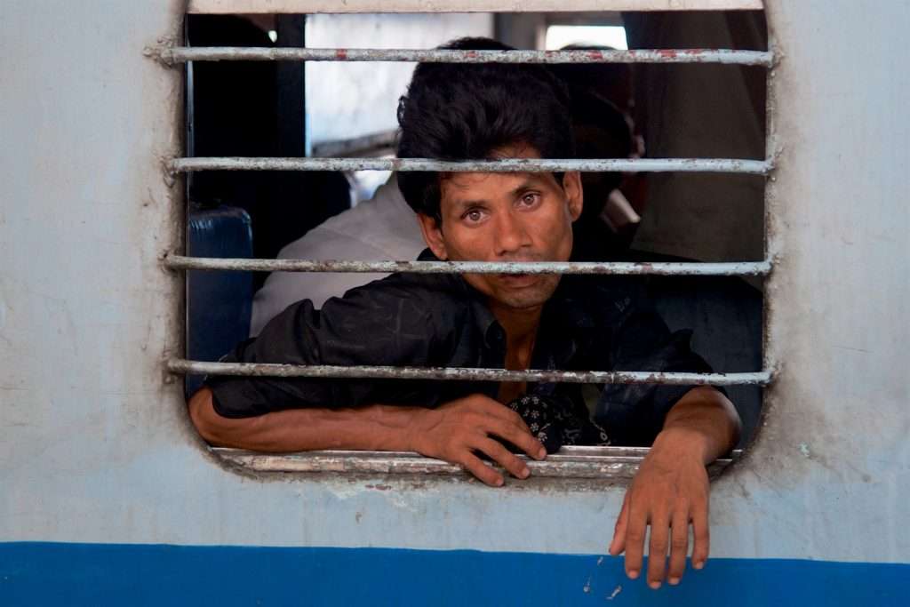 Sad Looking Man On Train At Delhi Train Station In India By Ralph Velasco