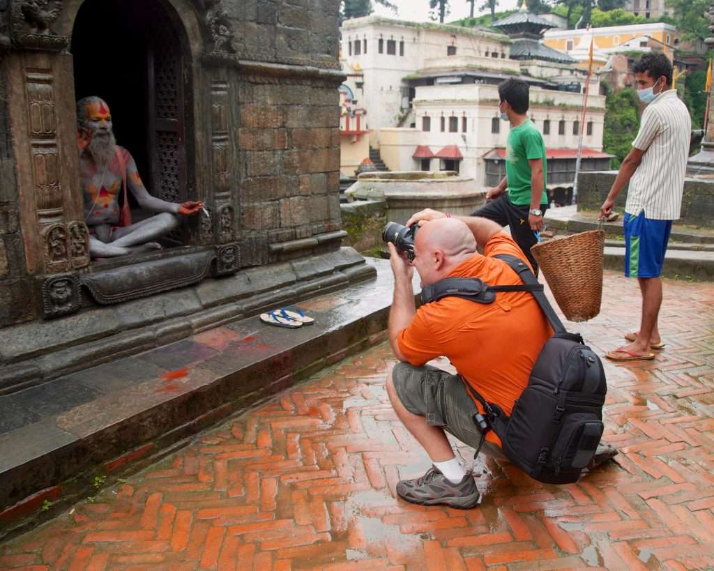 Ralph Velasco Photographing Sadhu In Temple Doorway In Pashupatinath, Nepal By Rebecca Foreman