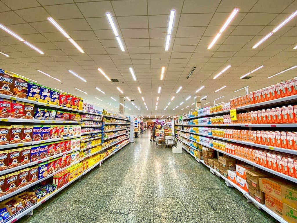 A Super Market Store With Lots Of Grocery Products In Shelves