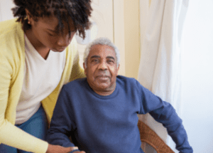 Can You Get Disability Insurance If You’re Already Sick Or Disabled? &Raquo; Photo Of A Black Young Woman Helping Her Father Get Out Of His Chair Canva 1 E1684250587160 300X215 1