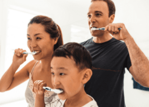 Surprising Links Between Medical Conditions And Oral Health &Raquo; Photo Of A Mother Father And Child Brushing Their Teeth Canva 1 E1688580078880 300X215 1