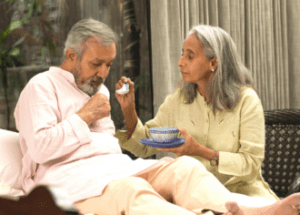 Help With Caregiving Stress &Raquo; Photo Of A Senior Indian Woman Feeding Soup To Her Senior Husband Who Is In Bed Canva E1681325535673 300X215 1