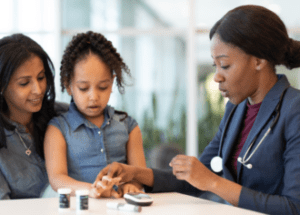 Tips For Newly Diagnosed Diabetes Patients &Raquo; Photo Of A Young Girl With Diabetes Sitting On Her Mothers Lap While A Doctor Checks Her Blood Sugar Levels Canva 1 E1688169771819 300X215 1