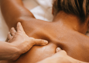 Health Benefits Of Massages &Raquo; Up Close Photo Of Hands Massage The Back Of A Woman Who Is Lying Face Down On A Massage Table Canva 1 300X214 1