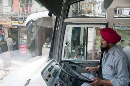 Tips For Staying Safe When Traveling &Raquo; Bus Driver In Seat Driving Delhi India Copyright 2011 Ralph Velasco 1024X680 1