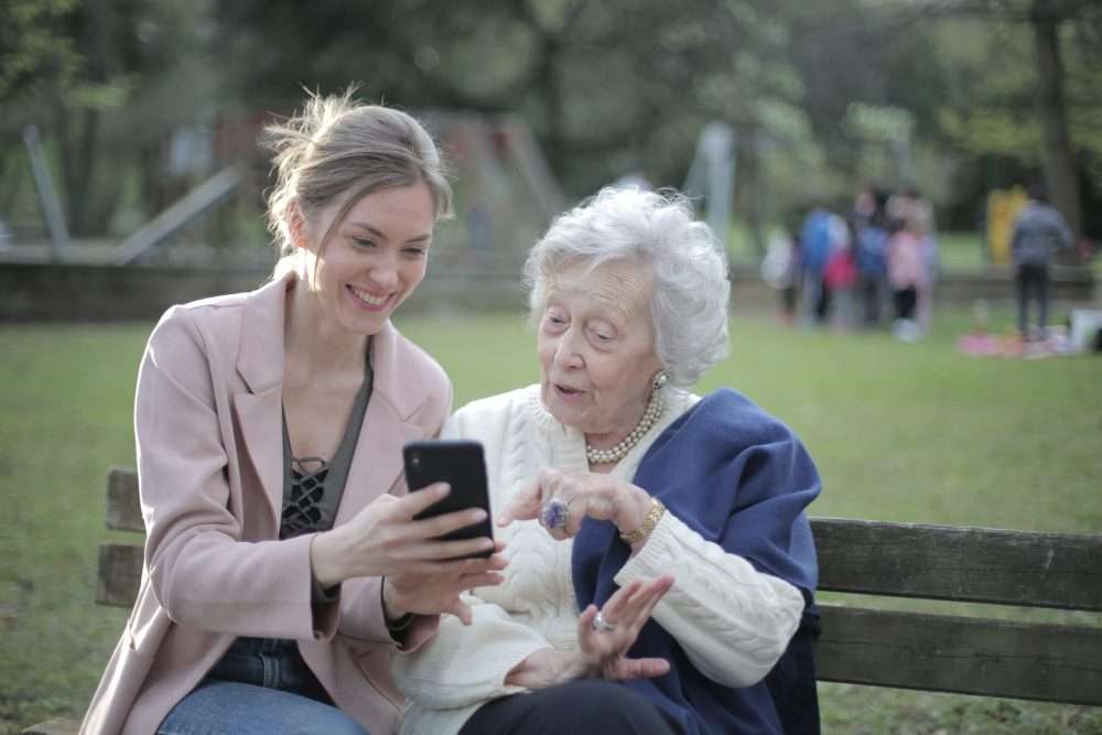 Daughter Showing Mother Something On Her Phone