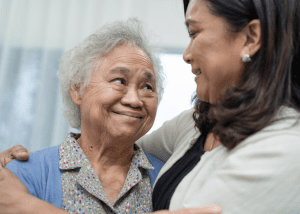 How To Care For A Loved One With Dementia &Raquo; Photo Of A Middle Aged Woman Hugging Her Senior Mother Both Of Them Smiling And Looking Lovingly At Each Other Canva 1 300X214 1