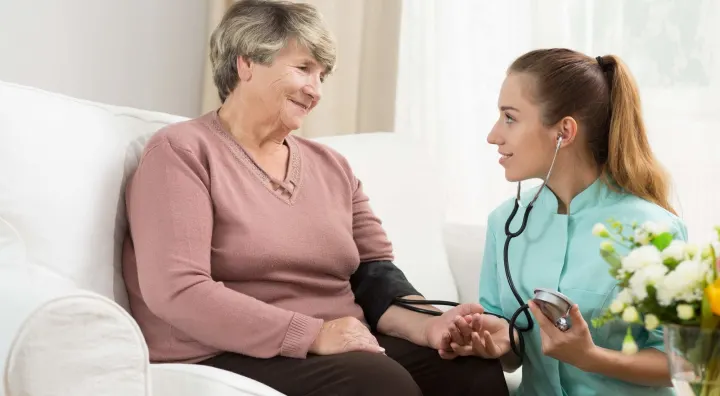 Senior Woman Getting Blood Pressure Taken At Home