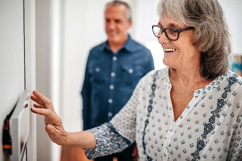 Senior Woman Setting Home Alarm System