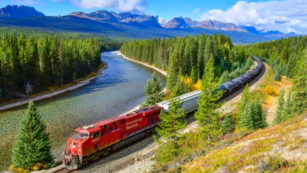 Alberta, Canada - October 1,2017: Long Freight Train Canadian Pacific Railway (Cpr) Moving Along Bow River In Canadian Rockies ,Banff National Park, Canadian Rockies,Canada.