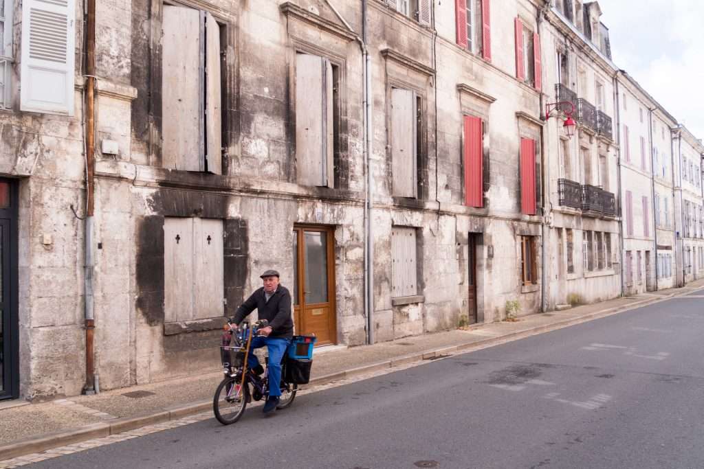 Exploring The Treasures Of France’s Dordogne Region: A Journey Through History, Culture, And Natural Beauty &Raquo; Man Riding Bike In Brantome Brantome France Copyright 2019 Ralph Velasco 1024X683 1