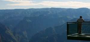 Exploring The Marvels Of Mexico’s Copper Canyon: A Journey Into Natural Wonders And Indigenous Culture &Raquo; Man On Bridge In Copper Canyon Divisadero Mexico Copyright 2011 Ralph Velasco 300X141 1