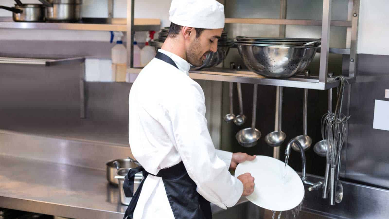 Man Washing Dishes In Restaurant