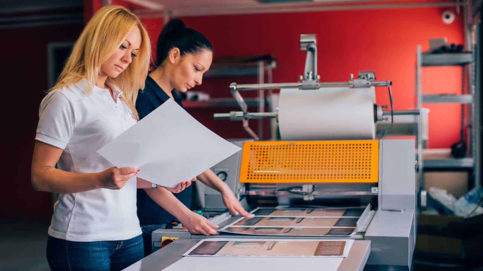 Two Young Woman Working In Printing Press