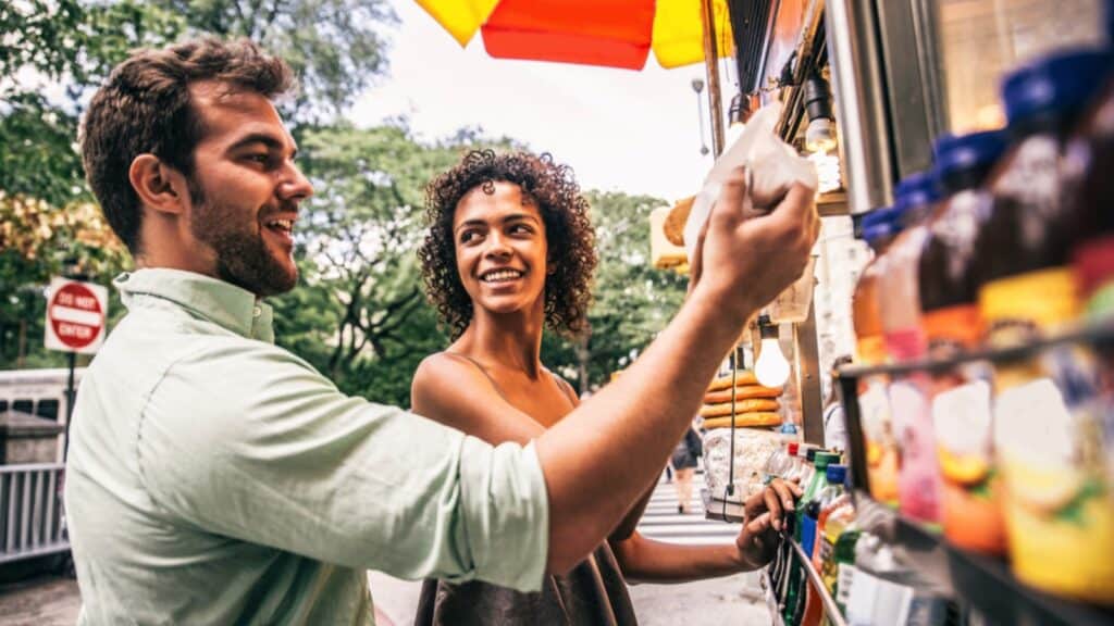 Couples Eating From Food Truck In New York