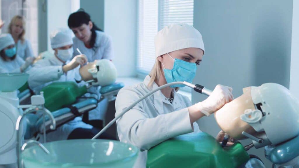 Students Practicing Dentistry On Medical Dummies In A Teaching Facility Or University