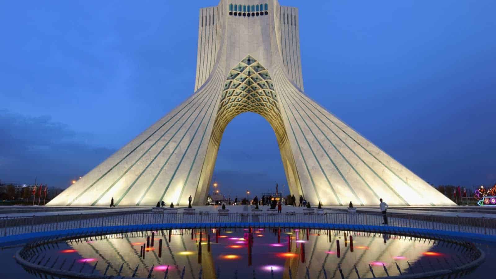 Tehran, Iran – April 04, 2019: Freedom Monument Known As Azadi Tower Or Borj-E Azadi Tower And Cultural Complex Reflecting In A Pond At Sunset, Tehran, Islamic Republic Of Iran