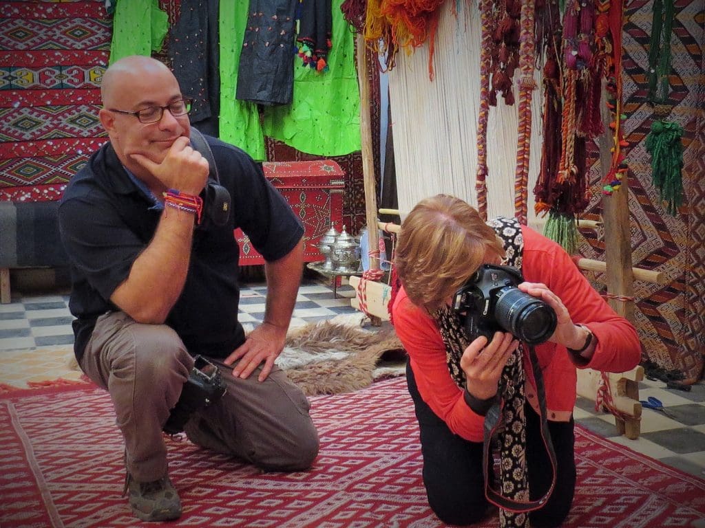 What Are The Benefits Of Small Group Tours? &Raquo; Ralph Velasco Working With Tour Participant In Berber Rug Shop Tinerhir Morocco Copyright 2014 Lois Brassart 1024X768 1