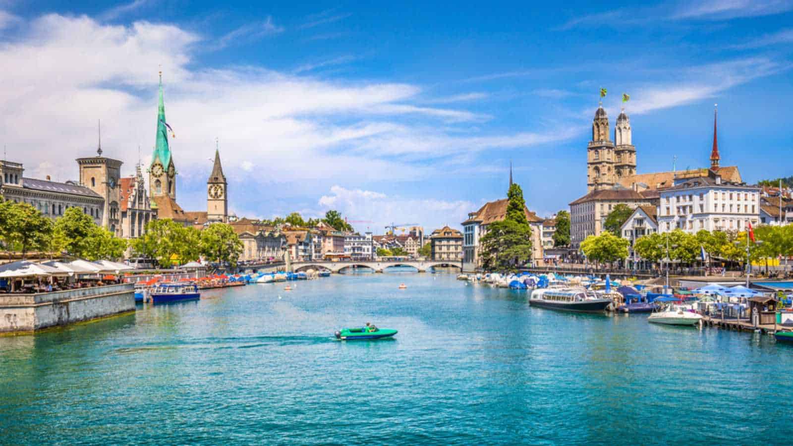 Panoramic View Of Historic Zurich City Center With Famous Fraumunster And Grossmunster Churches And River Limmat At Lake Zurich On A Sunny Day With Clouds In Summer, Canton Of Zurich, Switzerland