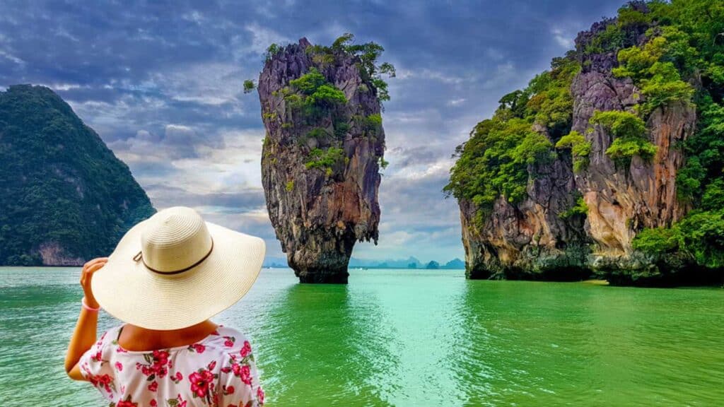 Woman Tourist With Hat And Floral Dress Looking At James Bond Island In Thailand