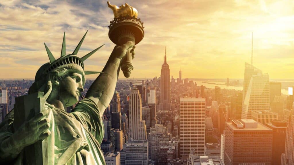 The Statue Of Liberty And New York City Skyline At Dark