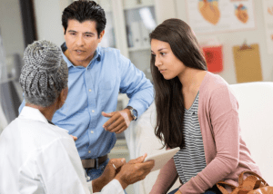 Understanding Cancer Treatment Options &Raquo; Photo Of A Young Man And Woman Having A Serious Talk With A Female Doctor Canva 1 300X214 1