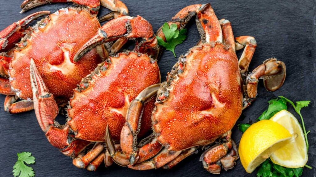 Cooked Crabs On Black Plate Served With White Wine, Black Slate Background, Top View.