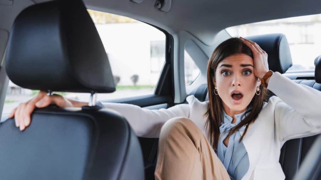 Scared Woman In Back Seat Of Car