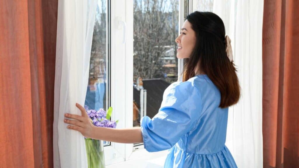 Woman Near Window Moving Curtain