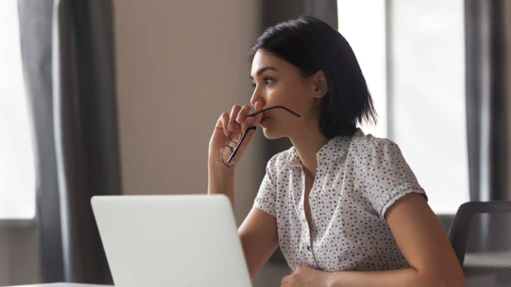 Woman With Laptop Thinking And Stressed