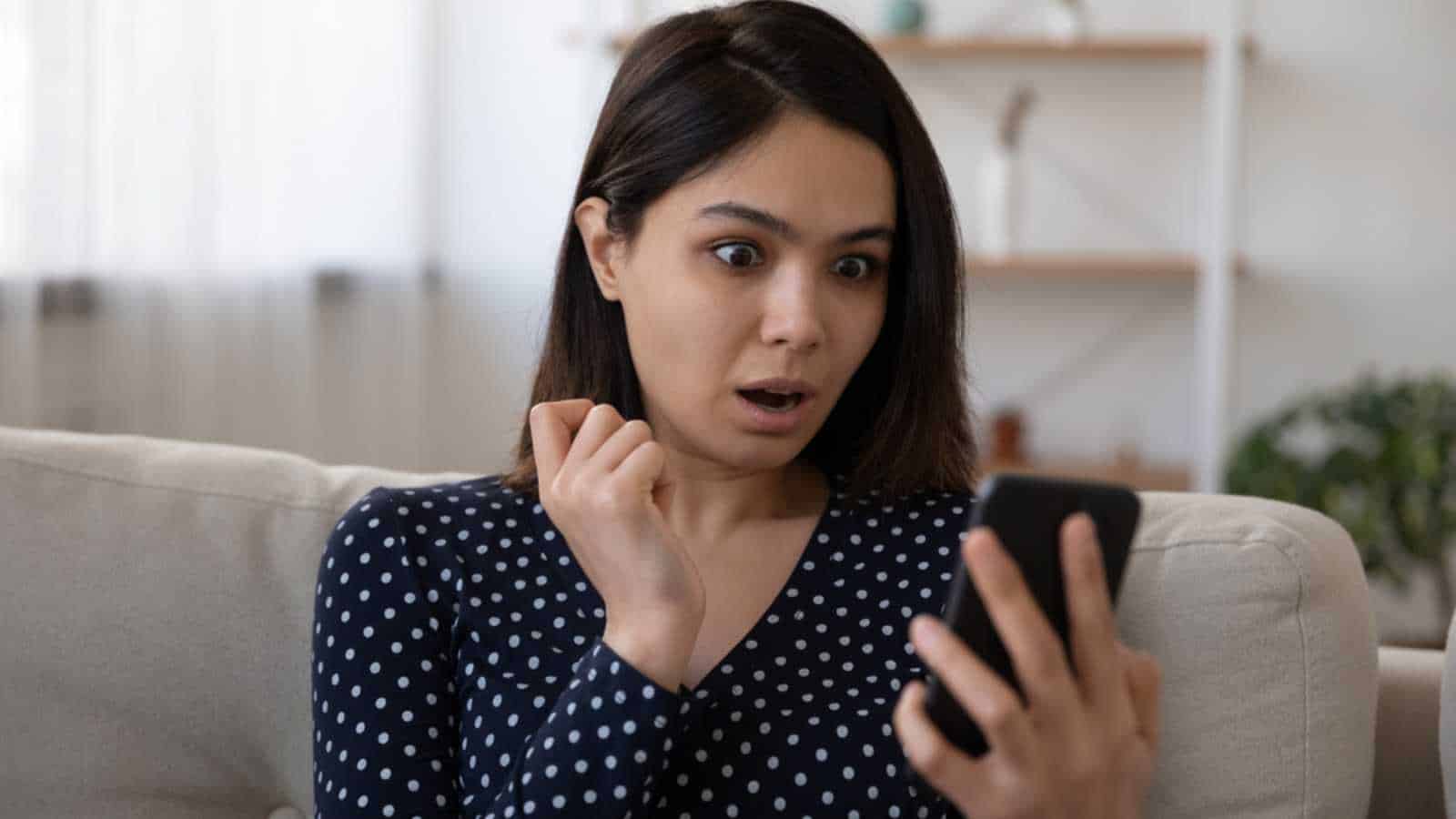 Woman With Mobile In Hand Shocked