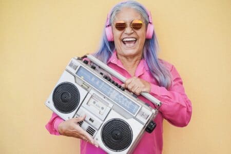 The Melodic Journey Of Baby Boomer Music: A Nostalgic Dive Into The Sounds That Shaped A Generation &Raquo; Happy Senior Woman Listening Music While Holding B 2023 11 27 04 56 46 Utc