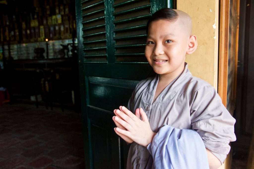 The Art Of Slow Travel: Embracing The Journey Over The Destination &Raquo; Little Boy With Clasped Hands At Temple Looking At Me Saigon Vietnam Copyright 2015 Ralph Velasco 1024X684 1