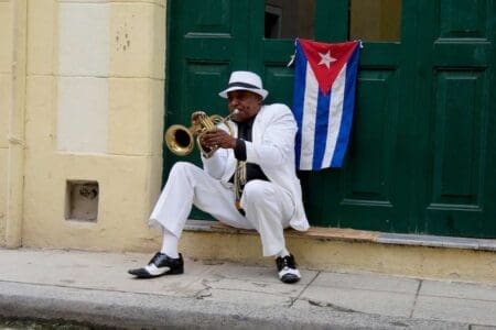 Is Cuba Safe For Americans? Your Comprehensive Guide &Raquo; Trumpet Player In White With Flag In Old Havana Havana Cuba Copyright 2016 Ralph Velasco