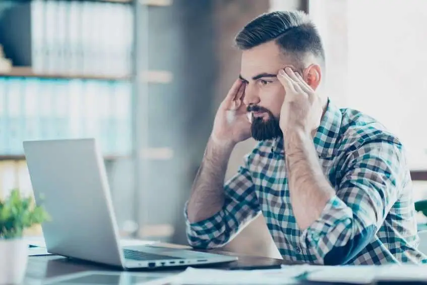 Thoughtful Guy Sitting At A Laptop