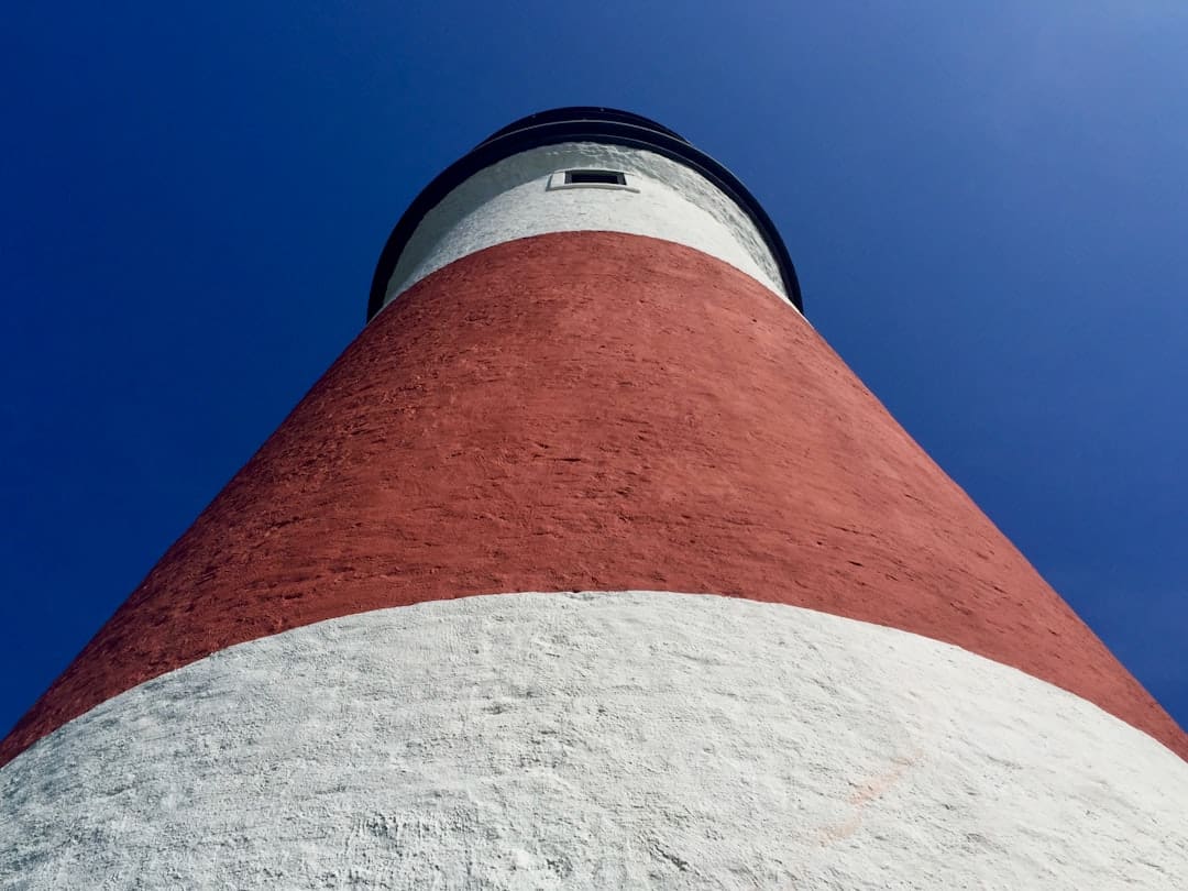 Red And White Concrete Tower Under Blue Sky During Daytime